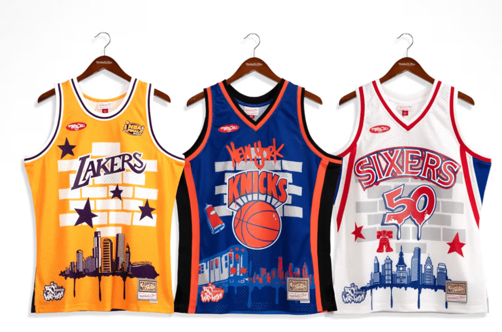 Mitchell & Ness & TATS Cru Drop Capsule Collection Honoring Hip-Hop’s 50th Anniversary