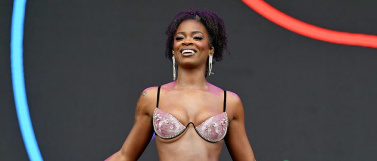 A Helmet-Wearing Ari Lennox Is Prepared For Any And All Objects Concertgoers Attempt To Throw Onstage