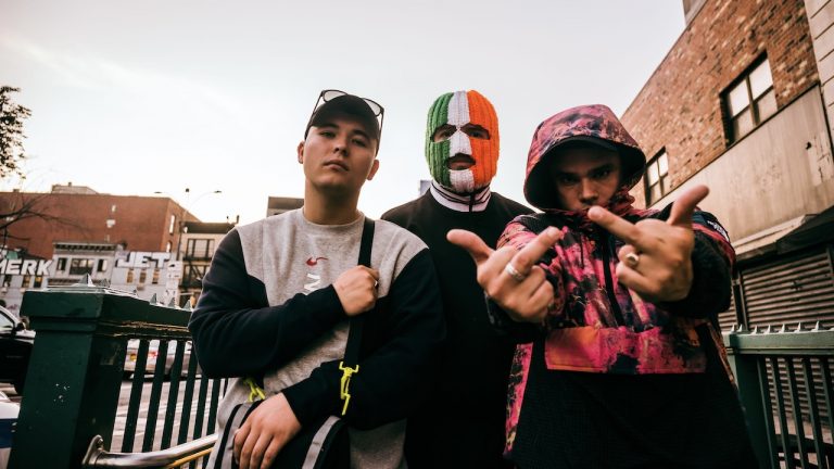 “Once again the British government is trying to silence voices from West Belfast – once again it will fail!”: Rising hip-hop stars Kneecap accuse the British government of trying to “silence” them after having funding blocked