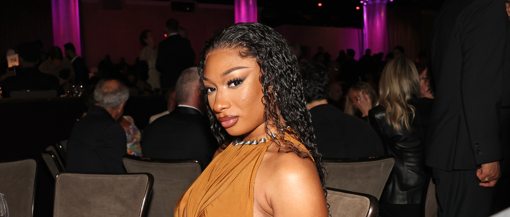 Megan Thee Stallion’s Slithering Sake Shot With An Actual Snake Has Folks Online Crawling In Their Skin