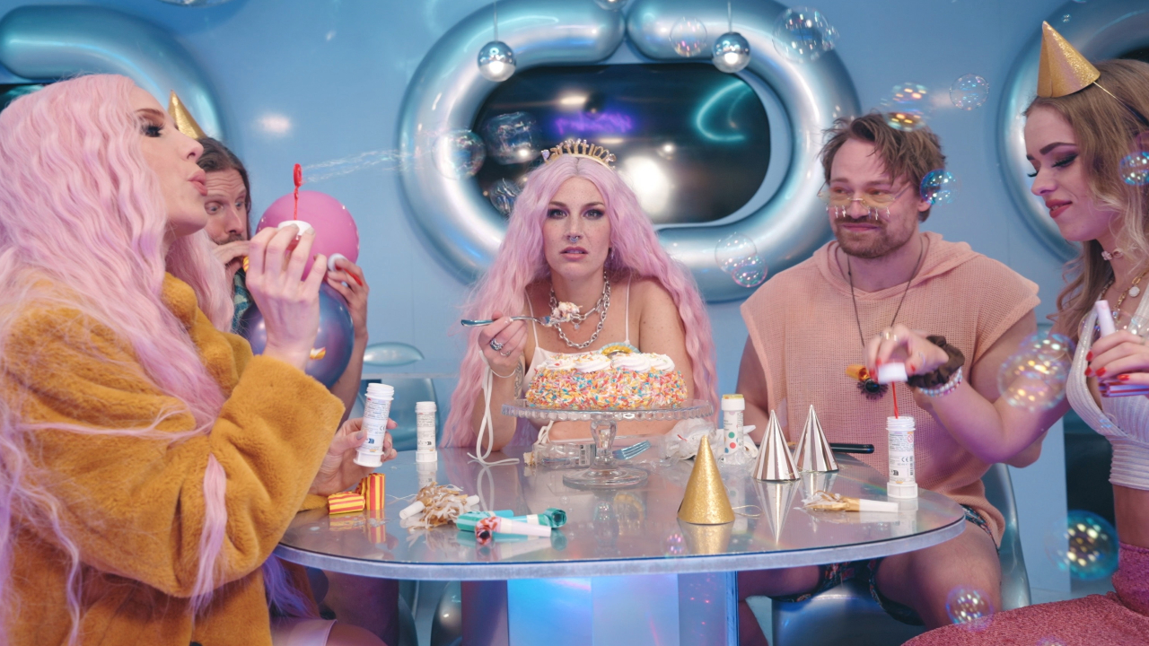 “It was great fun to let loose wearing pink wigs in ball pits and marshmallow pools”: See Charlotte Wessels (ex-Delain) and Simone Simons (Epica) team up in flamboyant Dopamine music video