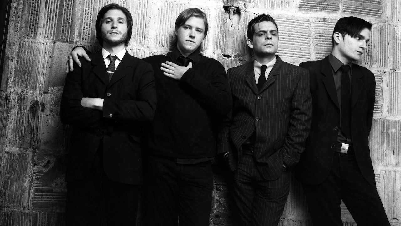 “Antics leaked 10 days after we finished it… you’d go to every city and someone would be talking about it”: Interpol on the premature release of their brilliant second record as it turns 20