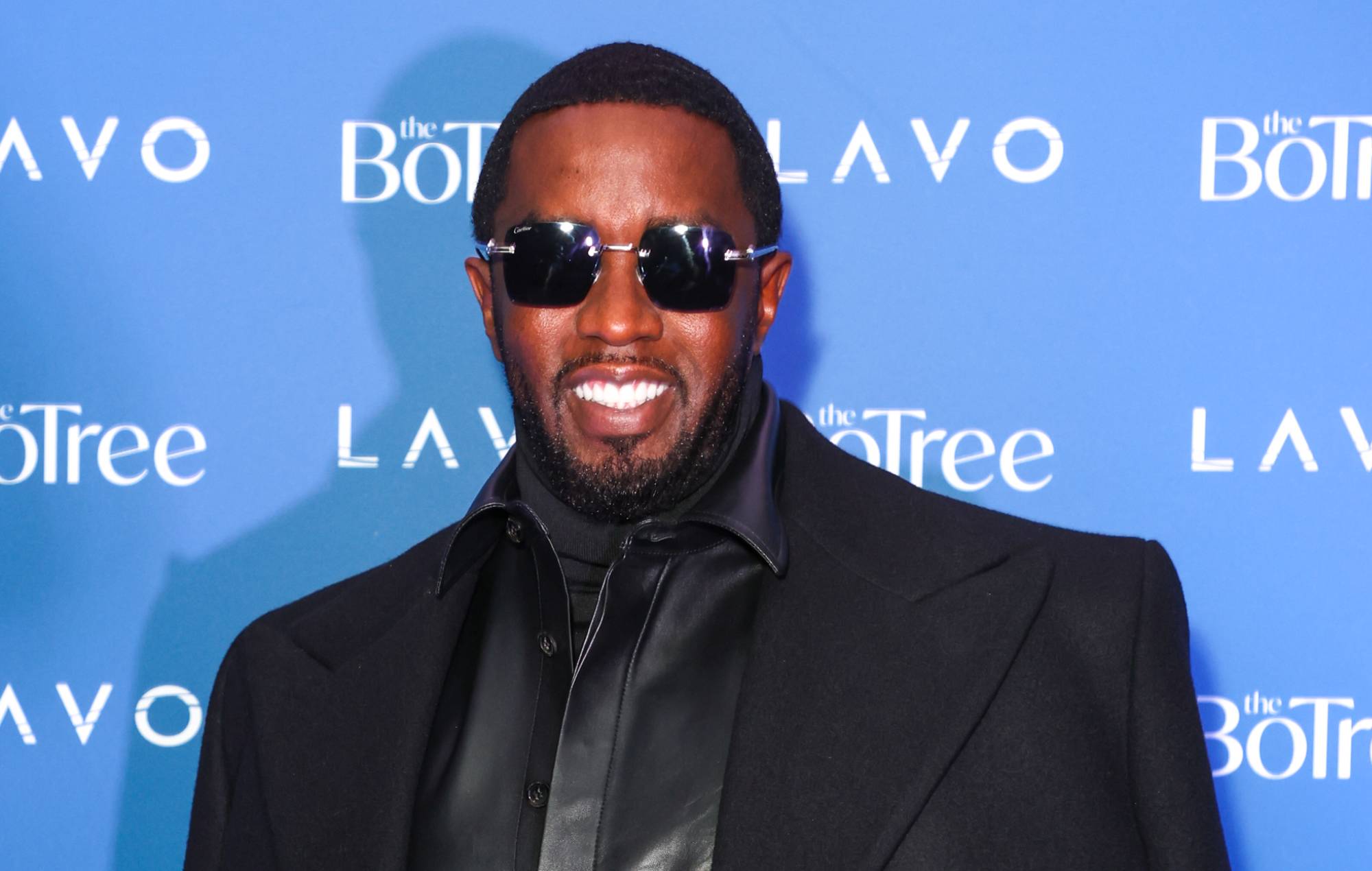 Woman accuses Diddy of threatening to kill her and dangling her over balcony