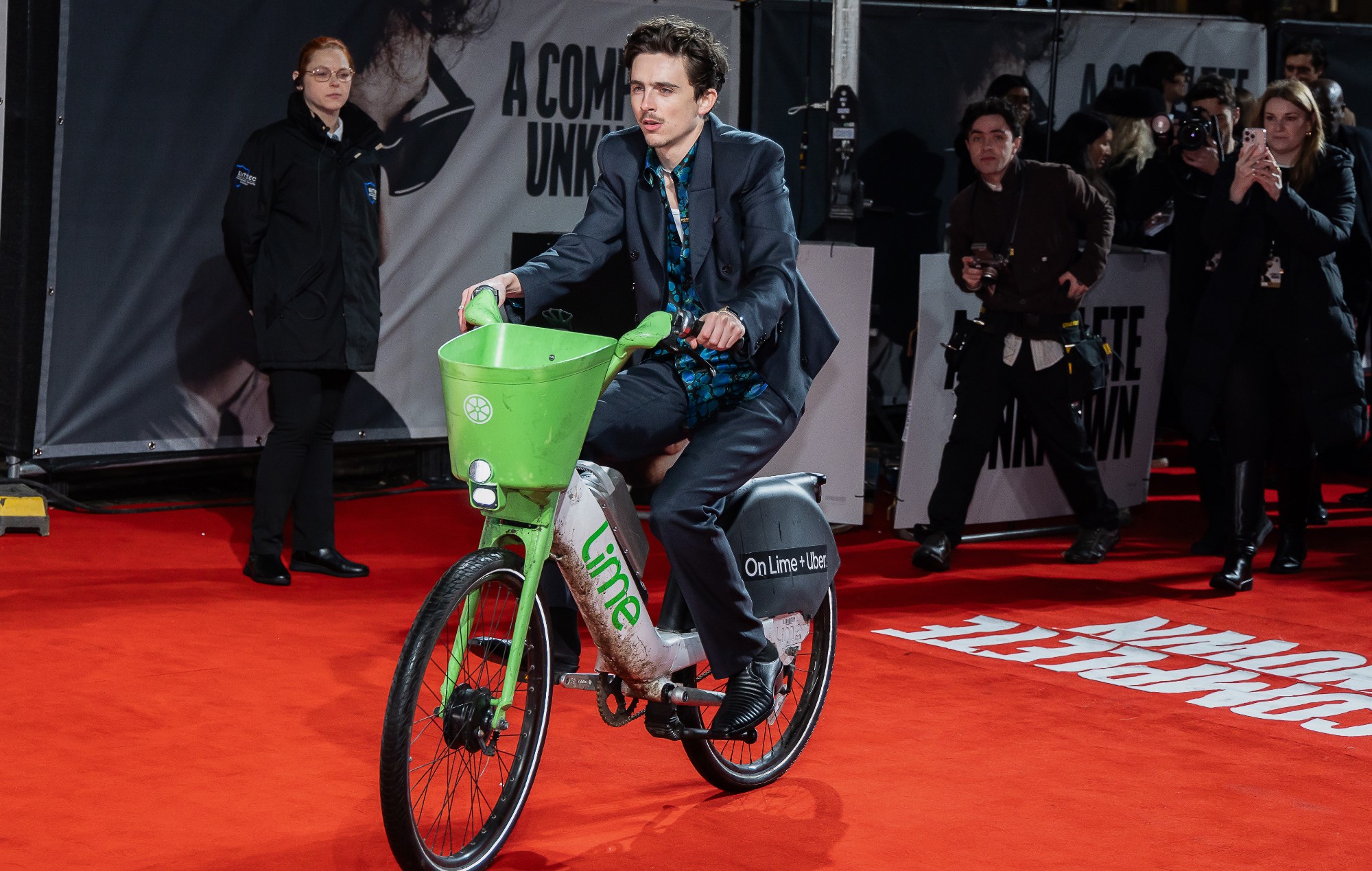 Timothée Chalamet rides Lime bike into London premiere of ‘A Complete Unknown’