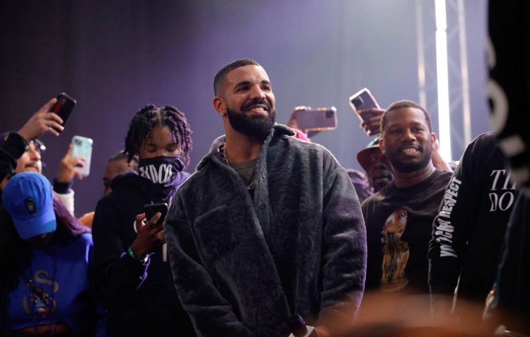 Drake fans go viral for “genuinely dystopian” gig signs asking him for money