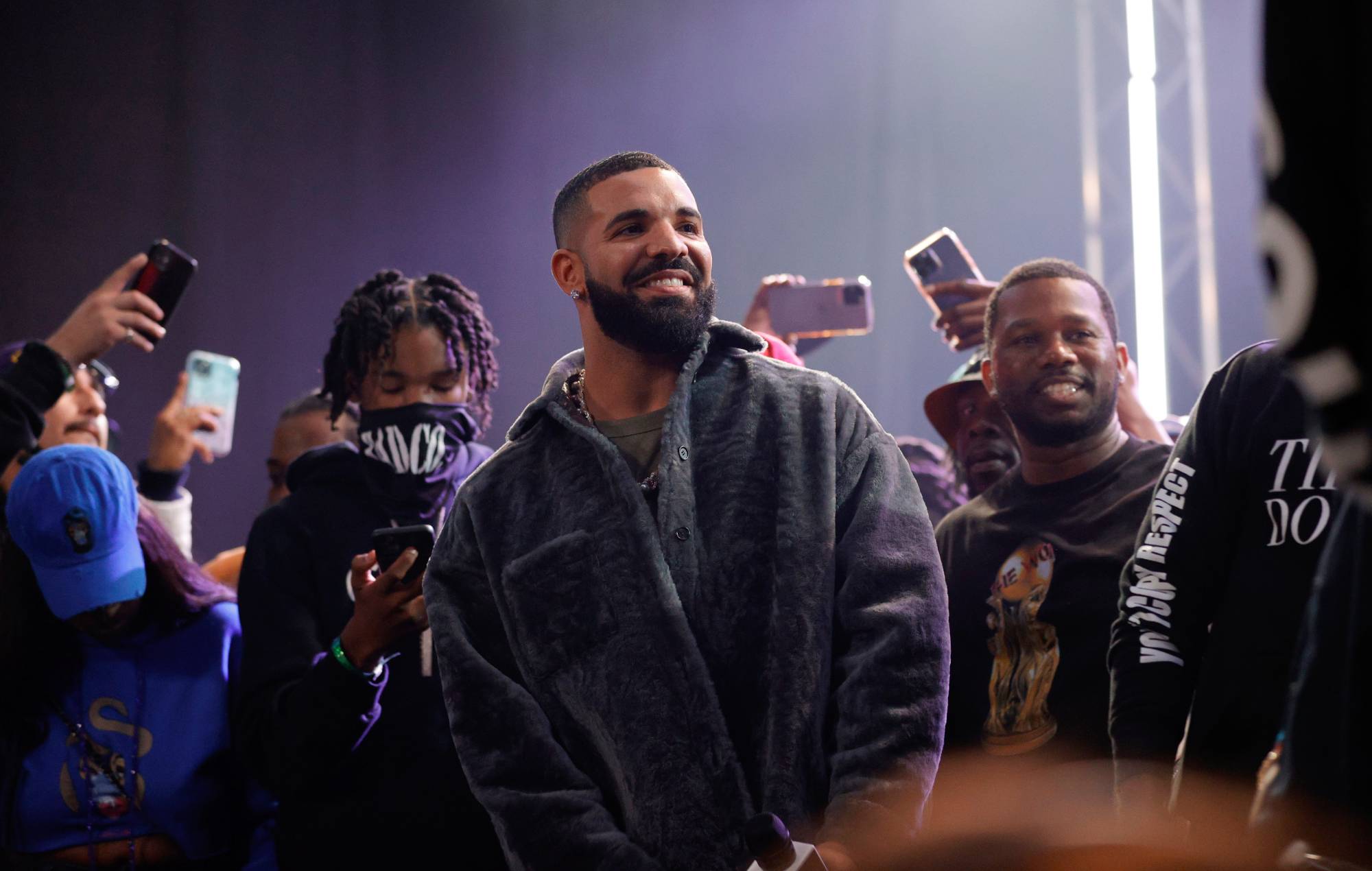 Drake fans go viral for “genuinely dystopian” gig signs asking him for money