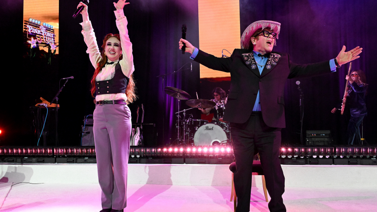 “She’s so kind to do this. She’s one of the biggest stars in the world right now”: Watch a pink sparkly cowboy hat-wearing Elton John perform Pink Pony Club with Chappell Roan at his Oscars viewing party