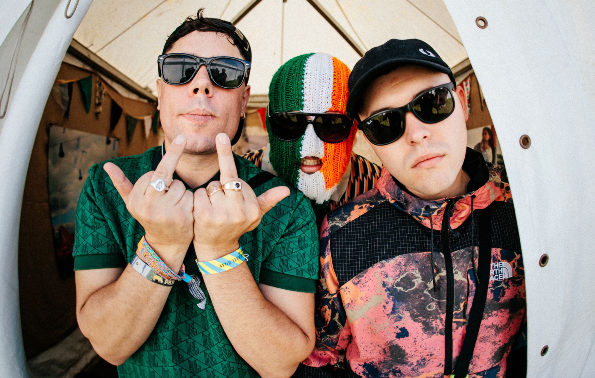 Kneecap urge fans to gather at Westminster with “a big bag of ket” for terror charge hearing