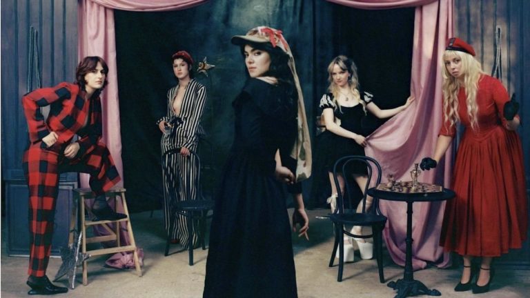 “Lyrics invoke rifles, scythes, sailors, saints, cowboys, floods, Mother Earth, Joan of Arc, and blazing infernos.” The Last Dinner Party announce second album From The Pyre, share dark, dramatic new single This Is The Killer Speaking