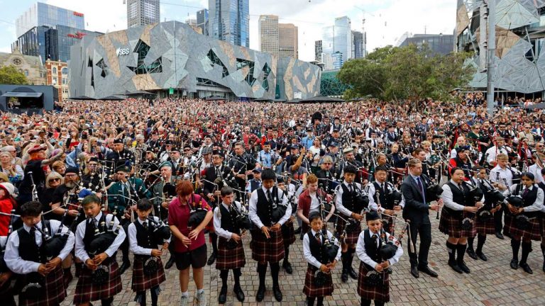 World’s largest bagpipe ensemble pays tribute to Bon Scott in Australia as AC/DC break out a classic for the first time in decades