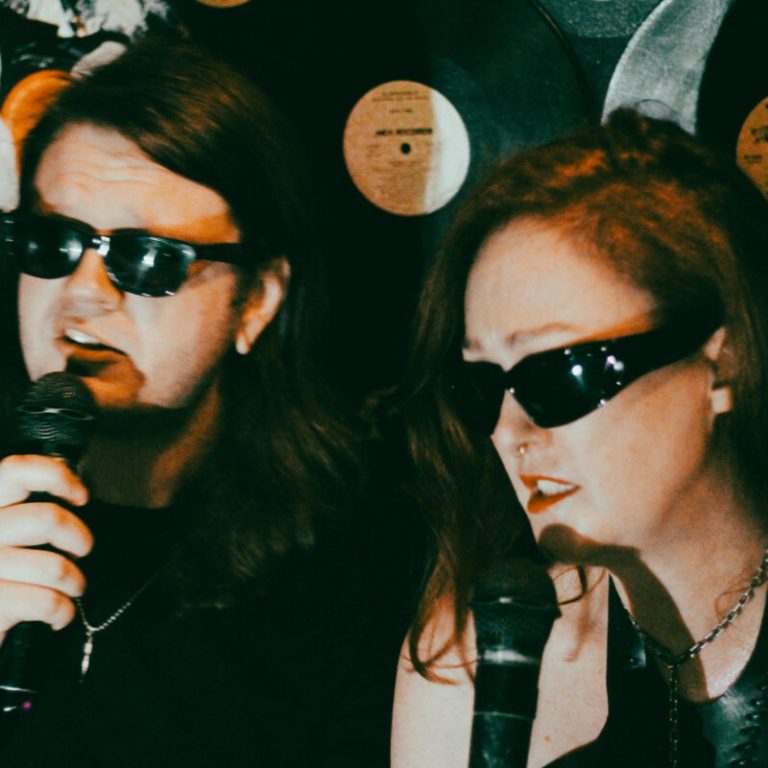 “Here I Am Missing You Again” — Child of Night Turn Synth-Pop Longing into Karaoke Catharsis in Video for “Old Moons”