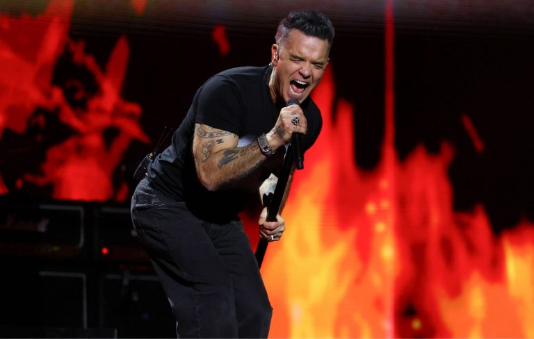 Robbie Williams hits back at “bully” podcaster: “I’m a real Redcoat. You’re a real bully. I know which one I’d rather be”
