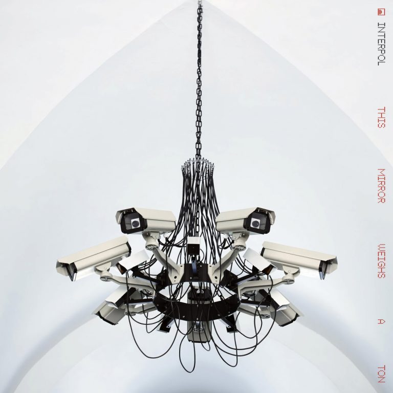 “Who Left a Crumbling Heart?” — Interpol Surveil the Grid in Video for “Iron City”