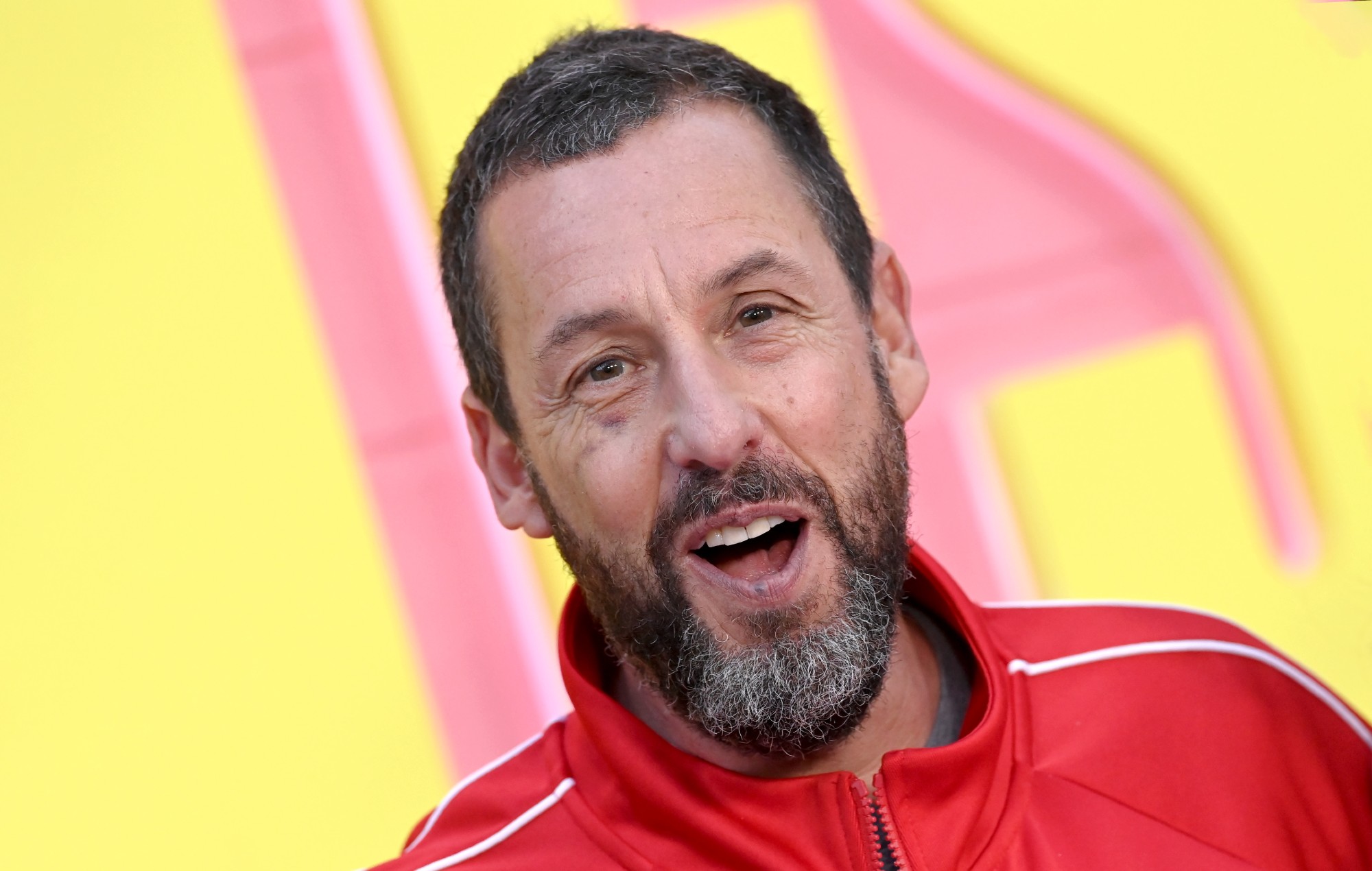 Adam Sandler wears socks when he goes swimming because “he can’t bend to take them off”